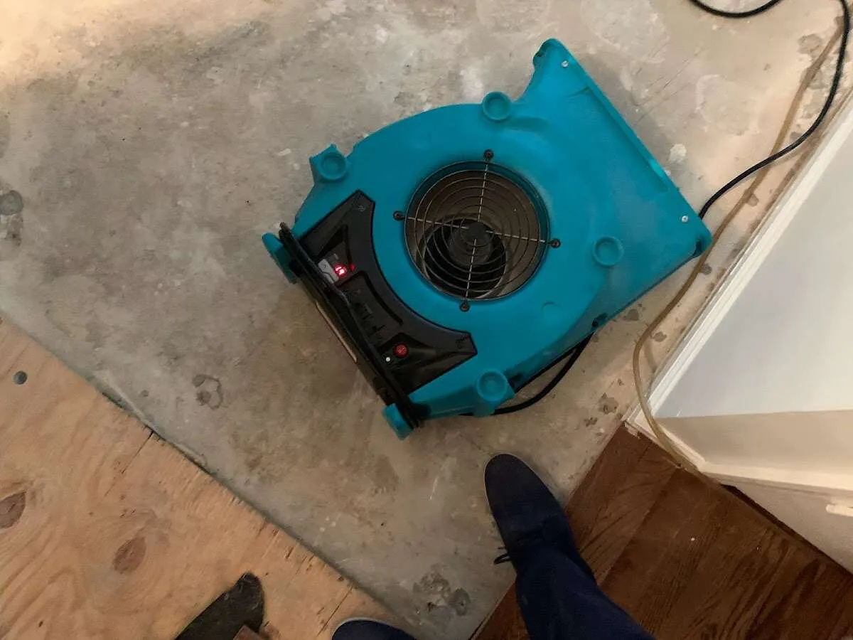 Air mover drying subfloor during Commercial Water Damage Restoration in Charleston